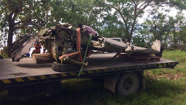 Wreckage of a helicopter being transported on a flatbed truck.