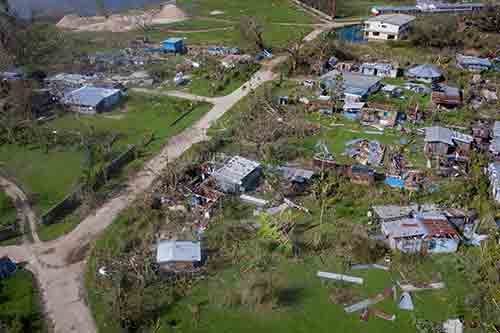 Aerial view of widespread destruction and damaged homes after Cyclone Harold