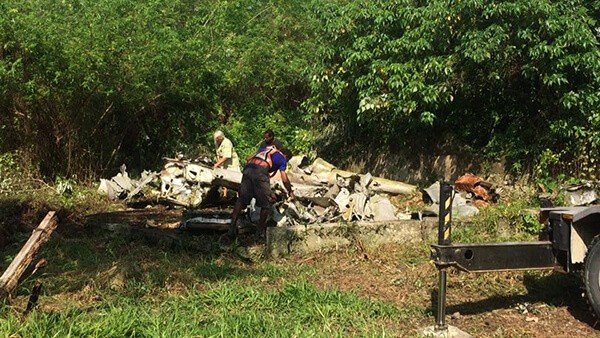 Debris from a plane crash being cleared by workers