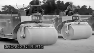 Two steamrollers marked "40 CB" with operators, black and white footage