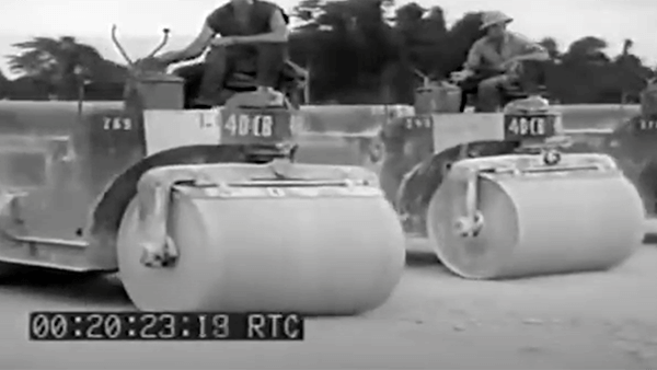 Two steamrollers marked "40 CB" with operators, black and white footage