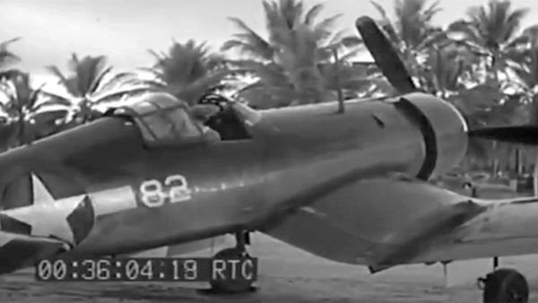Vought F4U Corsair aircraft with number 82 on its side, parked outdoors.