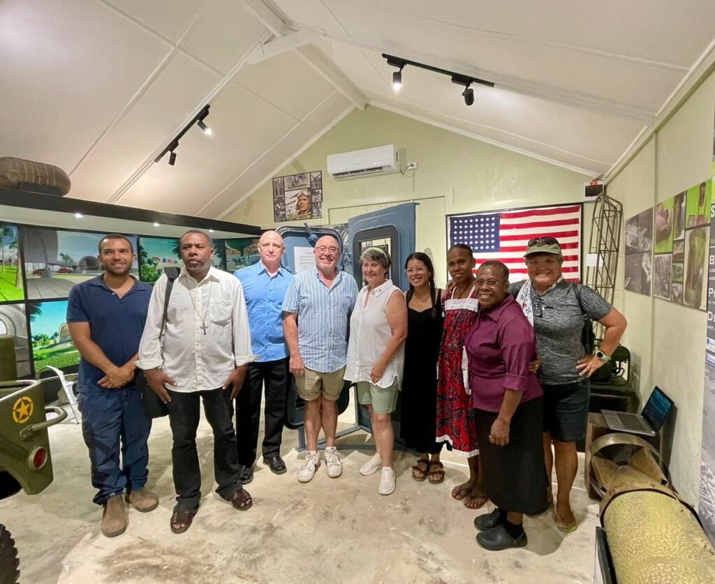 Group of people at a museum exhibit with American flag