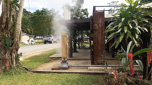 Steam rising from a wood-fired oven in a tropical setting.
