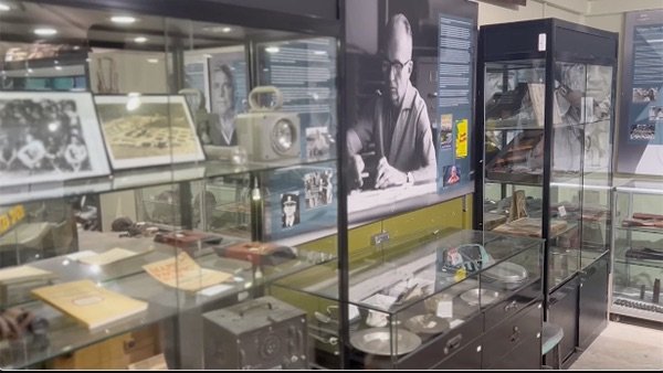 Museum display of vintage video equipment and historical photographs